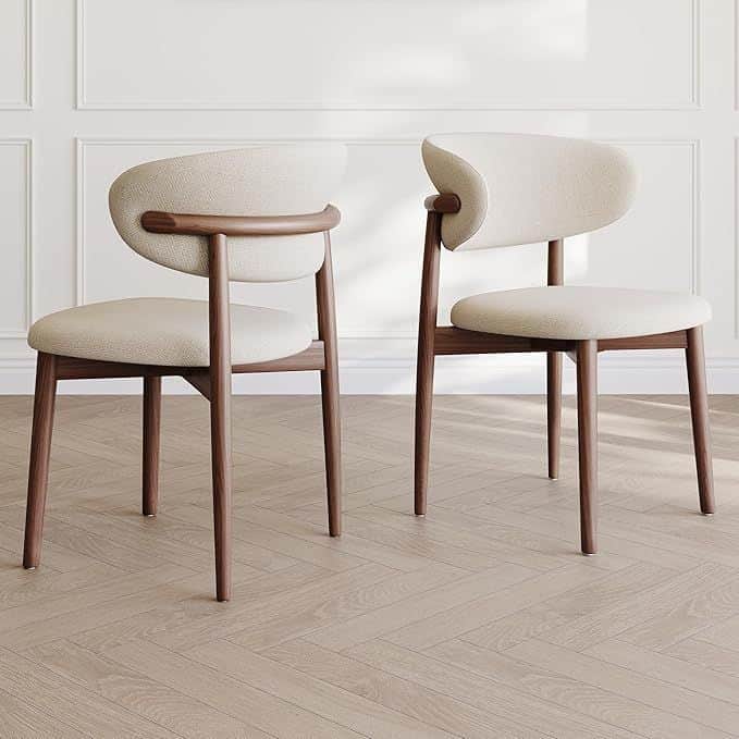 A modern dining chair with a curved backrest and a padded seat. The frame and legs are made of dark… — free GLB 3D model