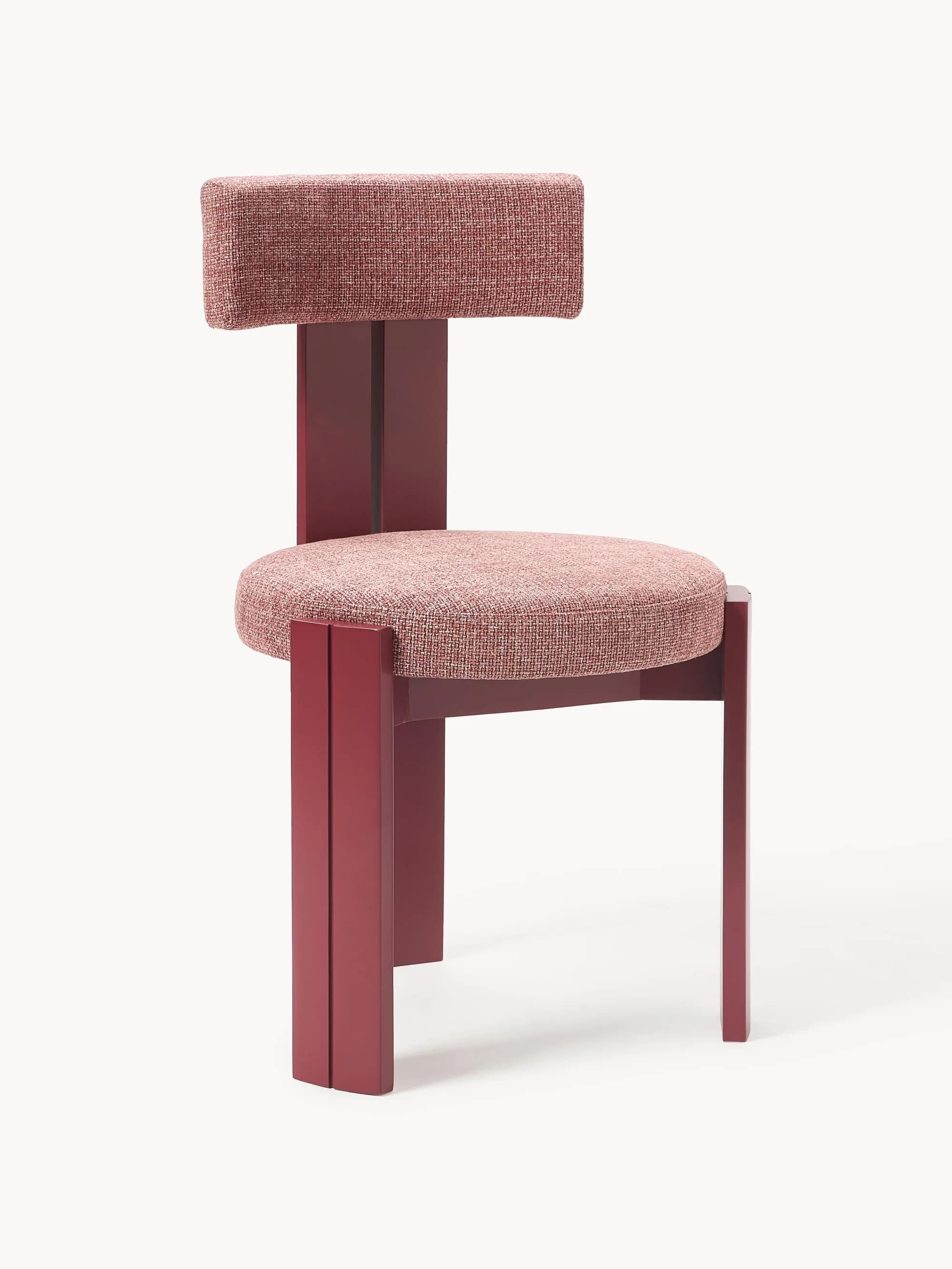 A modern chair with a rectangular seat and a distinctively shaped backrest. The frame and legs are constructed from a solid material, likely wood or metal, finished in a deep red hue. The seat and backrest are upholstered with a textured, reddish-pink fabric. The design features clean lines and a geometric aesthetic. — 3D model