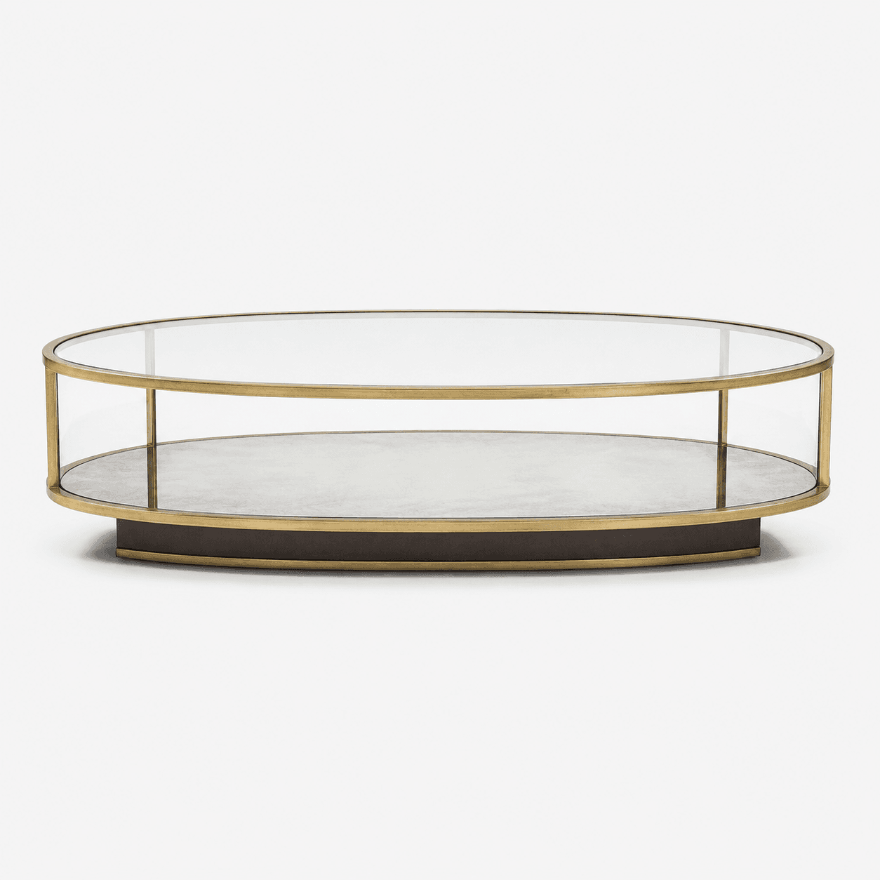 An elegant oval coffee table featuring a clear glass top and sides, enclosing a lower display shelf. The frame is constructed from brass-finished metal, and the table rests on a dark, oval-shaped plinth base. Its design allows for both surface use and the showcasing of decorative items within the enclosed lower tier. — 3D model
