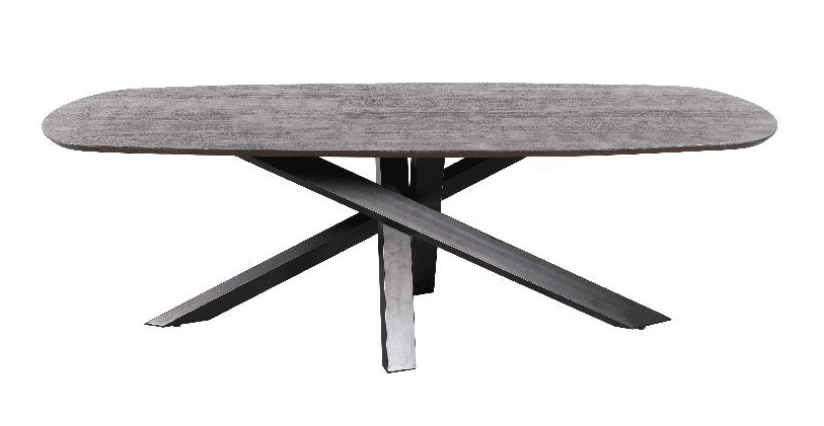 An oval dining table with a textured, light brown top and a dark, geometric metal base. The base consists of four angled legs that intersect, creating a striking visual dynamic. — 3D model