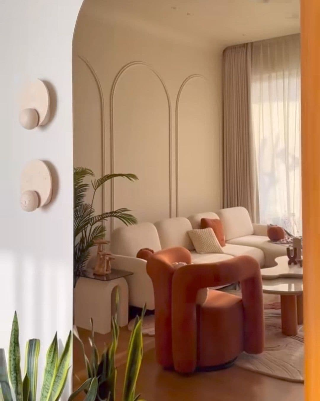 A contemporary sculptural accent chair featuring a plush, rounded form and a swivel base. The chair is upholstered in a textured terracotta or burnt orange fabric, presenting a soft, inviting aesthetic. — 3D model