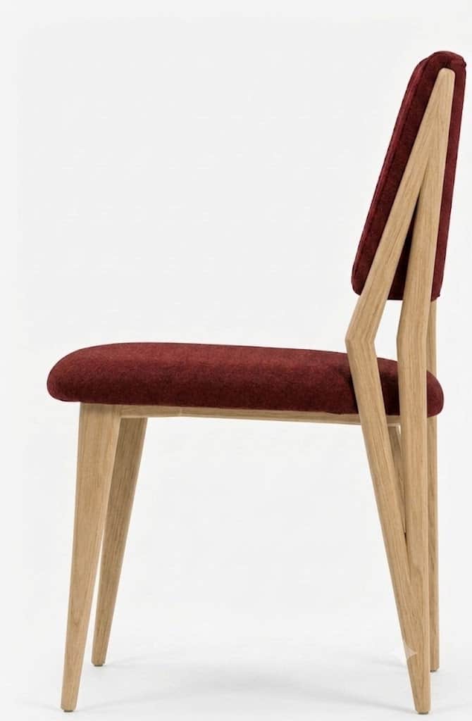 A contemporary dining chair featuring a light-toned wooden frame and deep red fabric upholstery. The… — 3D model