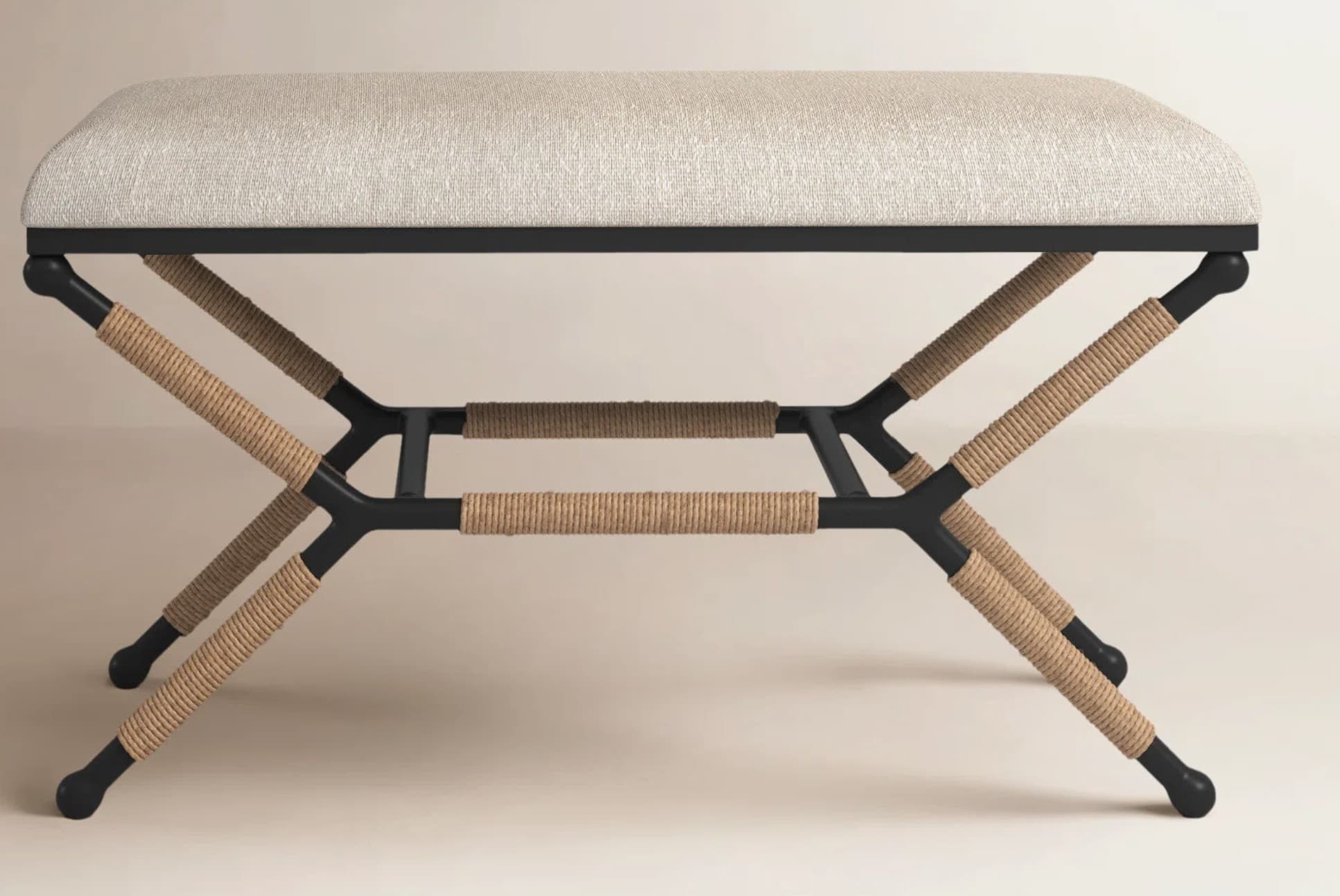 A rectangular upholstered bench featuring a black X-shaped metal frame with natural rope-wrapped accents. The seat cushion is covered in a light-colored, textured fabric. — 3D model