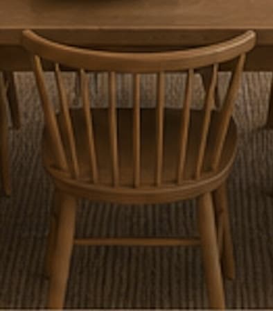 A light natural wood chair with a spindle back and a gently curved top rail, featuring a contoured saddle seat and splayed round legs joined by stretchers. — 3D model