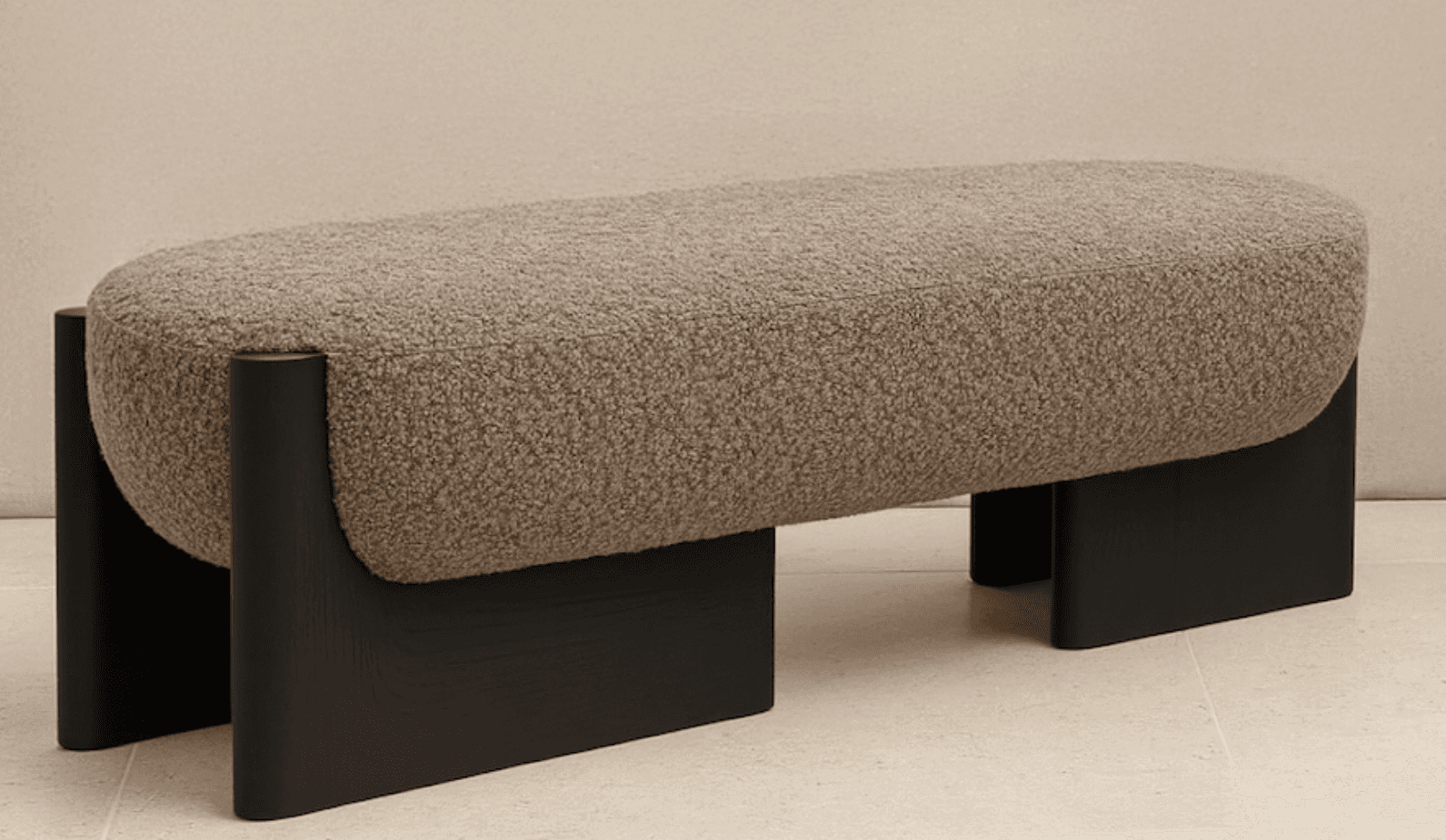 An elongated, pill-shaped bench featuring a textured boucle fabric upholstery in a neutral beige/tau… — 3D model