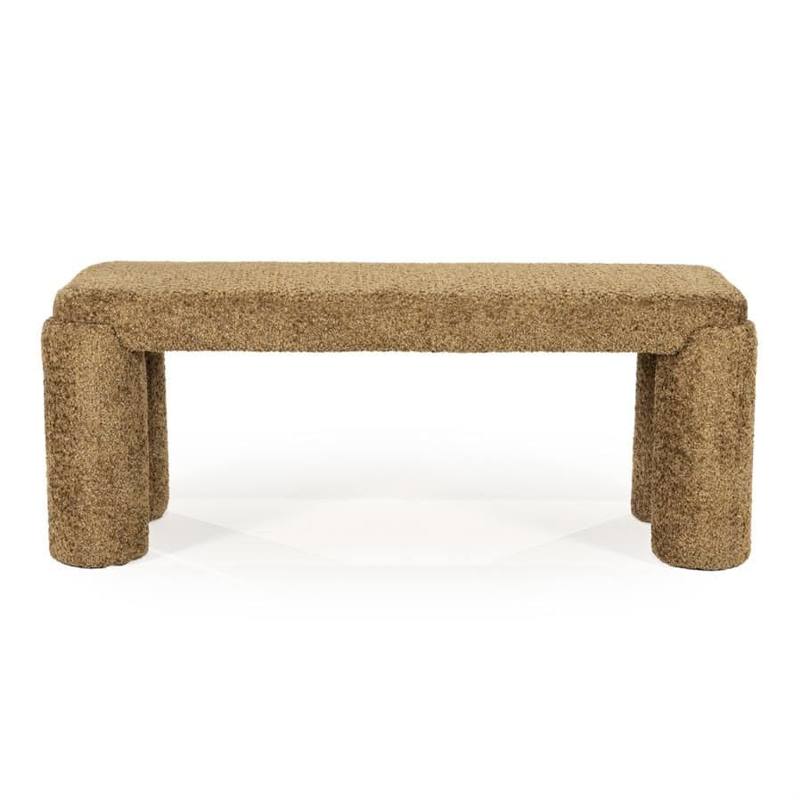 A fully upholstered bench featuring a rectangular top and four stout, cylindrical legs, all covered in a textured boucle fabric of a light brown or tan color. The design is monolithic and contemporary, with soft, rounded edges. — 3D model