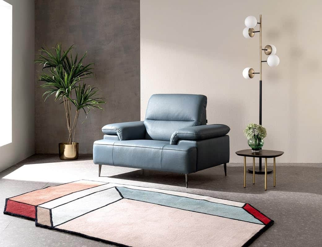 A modern single-seater armchair upholstered in a soft blue-grey leather, featuring generously padded… — 3D model