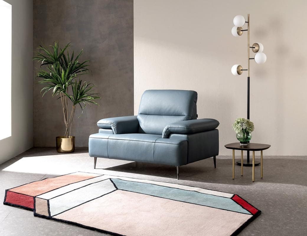 A modern single-seater armchair upholstered in a soft blue-grey leather, featuring generously padded cushions, subtly rolled arms, and slender metal legs with a polished finish. — 3D model