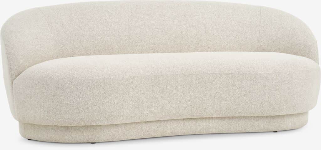 A modern, upholstered sofa with a curved silhouette and a low-profile base. The sofa features soft,… — 3D model