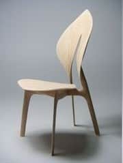 A modern, sculptural chair made from light-toned bent plywood, featuring an organically curved backr… — 3D model