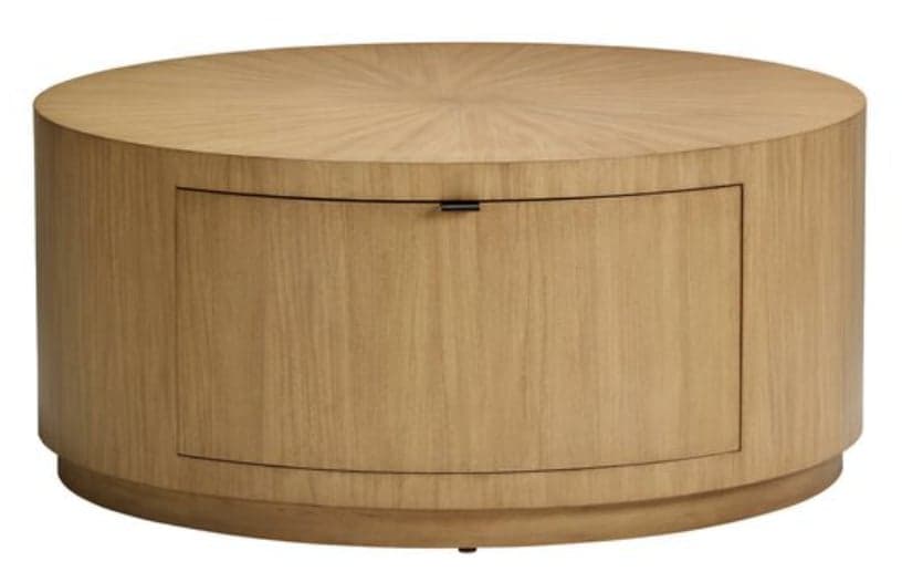 A light-toned cylindrical wood coffee table featuring a radiating veneer pattern on its circular top surface. The table includes an integrated, curved storage door or drawer with a small black handle on its front, and rests on a subtly recessed plinth base. — 3D model