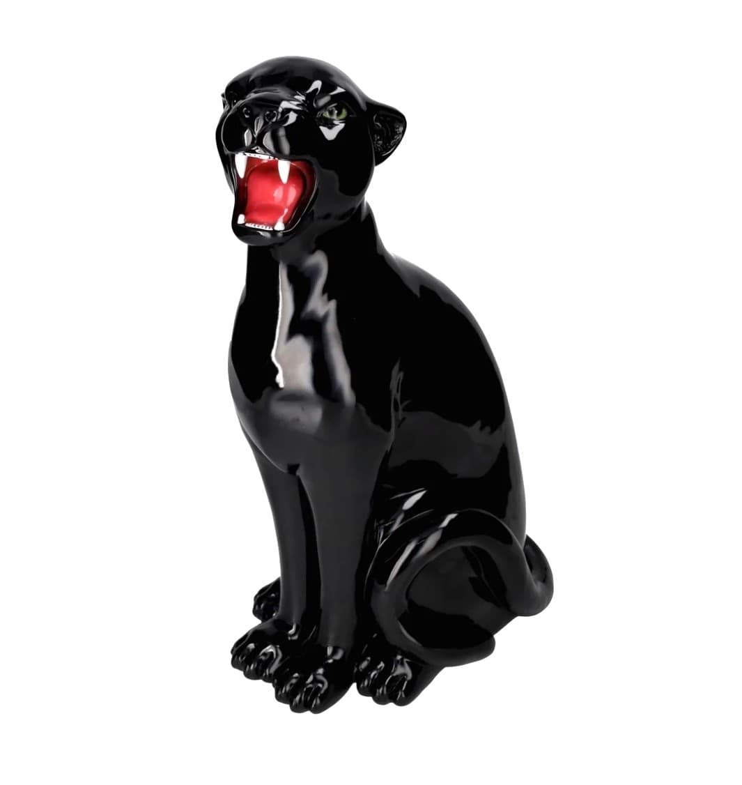 A highly polished black ceramic sculpture depicting a stylized panther in a seated, roaring pose, featuring vivid green eyes and a detailed red mouth with white fangs. — 3D model