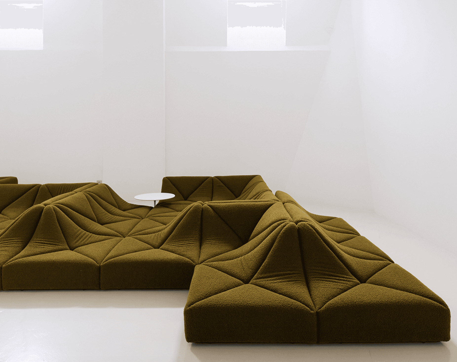 A large, olive green modular sectional sofa featuring a highly sculptural and geometric design with faceted, undulating surfaces that create an abstract, topographical landscape aesthetic. — 3D model