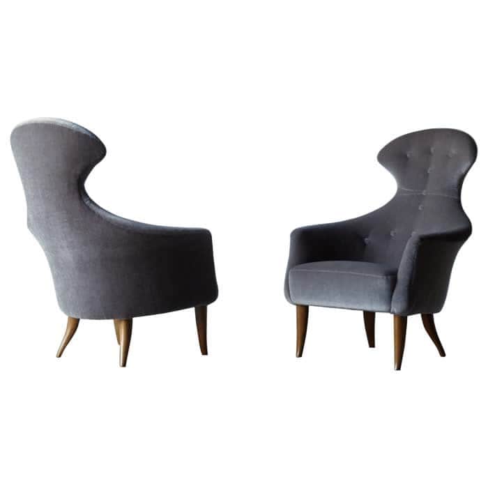 A mid-century modern inspired armchair with a high, sculpted backrest and tufted detailing. The chai… — free OBJ 3D model