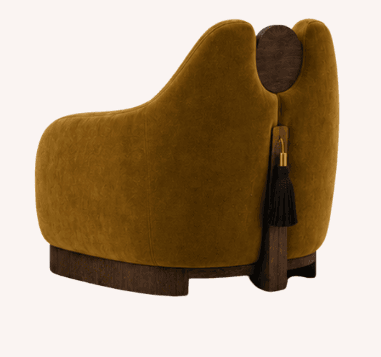 An upholstered accent chair featuring a rich, olive-green velvet fabric and distinctive dark wood elements. The chair has a rounded, contemporary silhouette with a deep seat and integrated arms. The most striking feature is its back, which incorporates a cut-out revealing a circular dark wood disc and a vertical dark wood accent panel from which a black tassel with brass hardware hangs. The chair is supported by a solid dark wood plinth-style base. — 3D model
