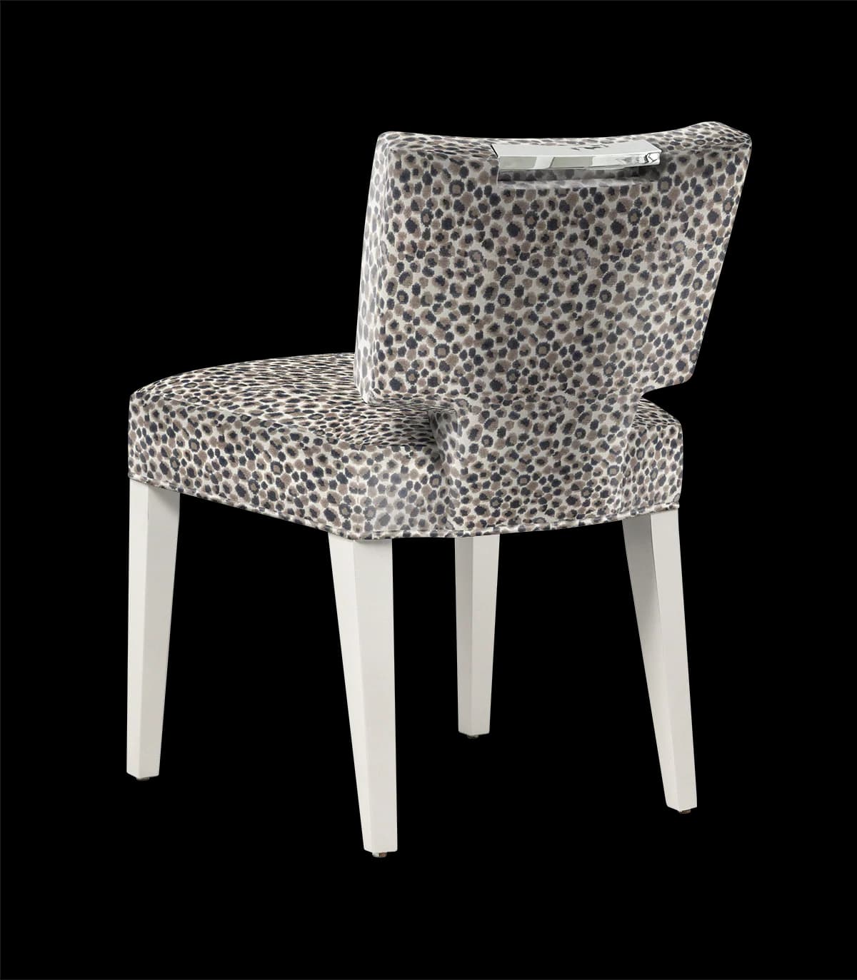 An upholstered accent chair with a unique leopard print fabric on the seat and back. The chair has four tapered legs and a decorative metal accent at the top of the backrest. The legs are finished in a contrasting white color. — 3D model