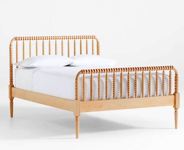 A wooden bed frame with a headboard and footboard featuring a spindle design. The frame has a light… — 3D model