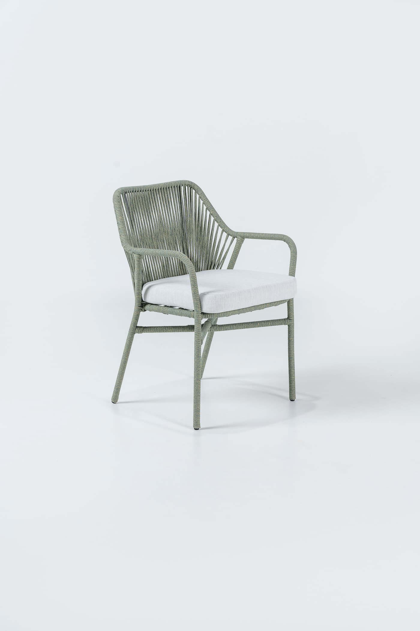 An armchair with a frame constructed from a tubular material, likely metal, wrapped in green cord or rope. The seat and back are formed by a taut mesh of vertically oriented green cords, creating a woven effect. A separate, light-colored cushion is placed on the seat. The armchair has a modern design, suitable for outdoor or indoor use. — 3D model