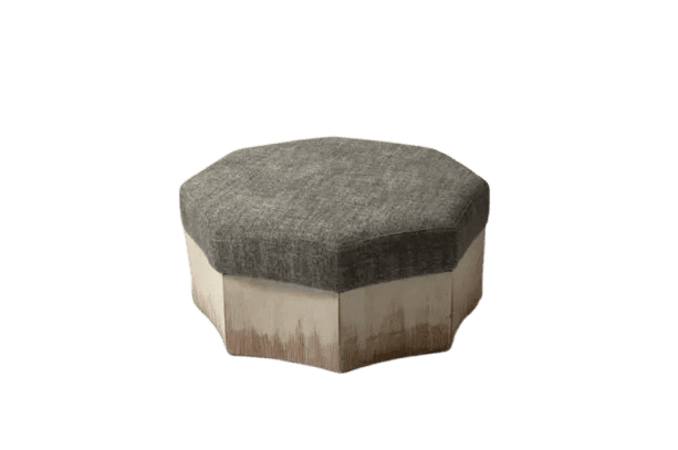An octagonal upholstered ottoman featuring a textured grey fabric cushion on top and a faceted base with a distressed, light-colored finish. The base has visible vertical brushstrokes, suggesting a rustic or artisanal touch. — 3D model