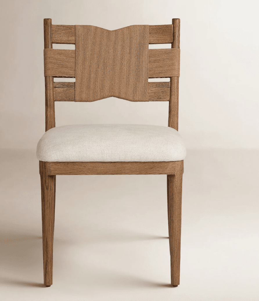 A modern dining chair featuring a light-toned solid wood frame, a distinctive backrest with vertical woven rope and horizontal rope accents, and a light beige upholstered seat cushion. The chair has straight, slightly tapered legs. — 3D model