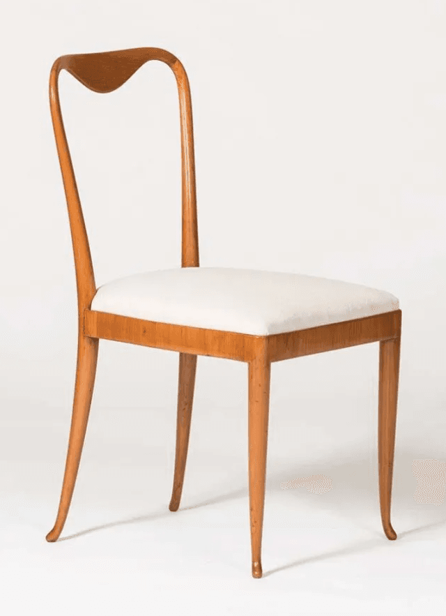 A side chair with a curved wooden frame and a cushioned seat. The backrest has a distinctive heart-shaped silhouette. The legs are slender and tapered, with a slight outward curve towards the bottom. — 3D model
